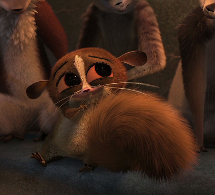 Cute animated character with big eyes and fluffy tail, sitting among friends, evoking an endearing "aww" reaction.