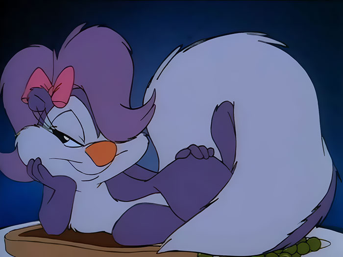 Cute animated character with purple fur and a pink bow, lounging with a playful expression.