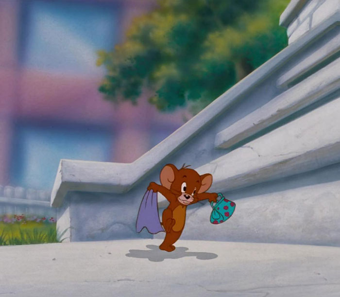 Cute animated character Jerry happily walking with a tiny bag beside stone steps.