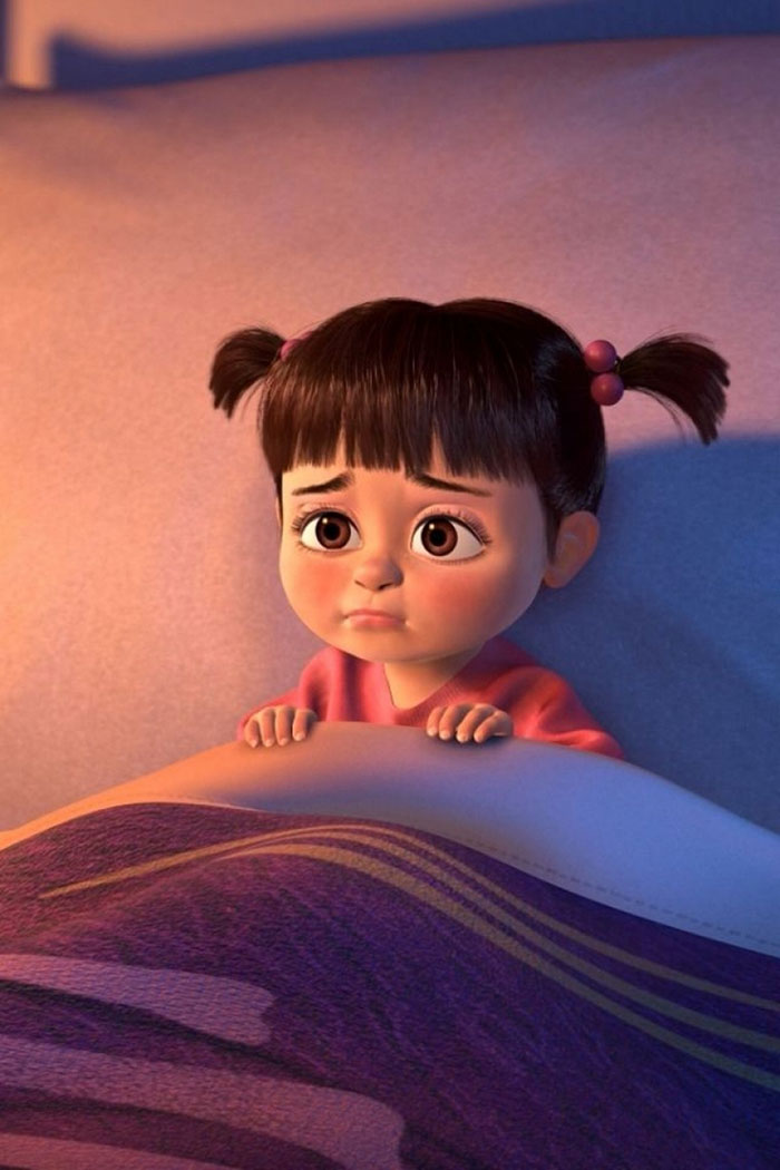 Cute animated character in bed with a worried expression, wearing a pink shirt and pigtails.
