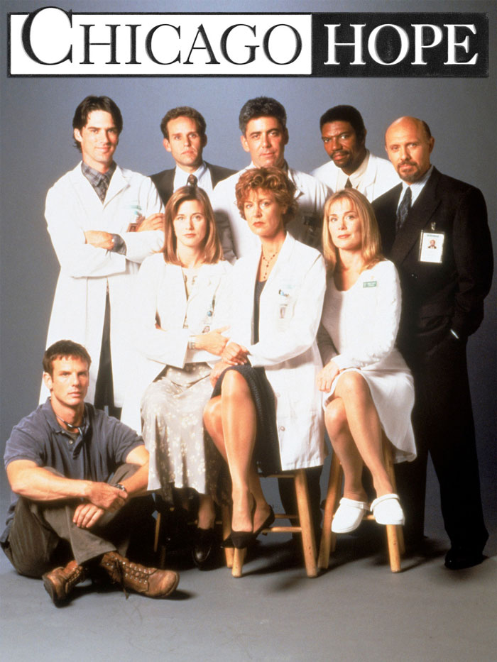 Cast of a medical TV show including doctors and medical workers in professional attire.