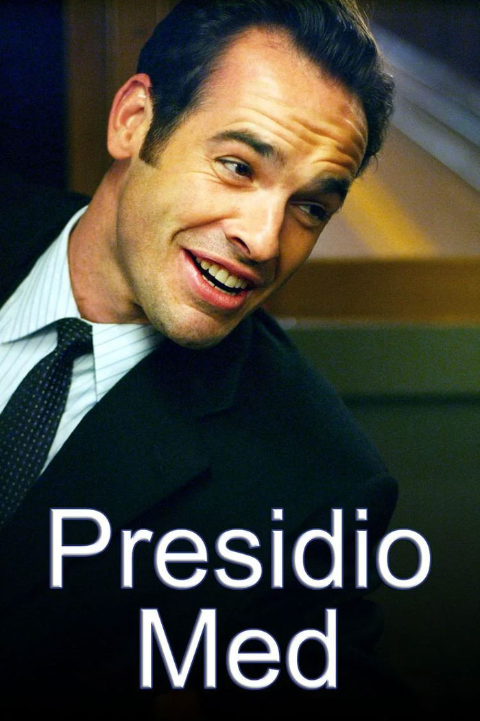 Smiling man in a suit representing TV show about doctors, "Presidio Med."
