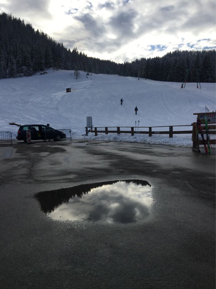 Just Some Snow On The Hills And A Puddle