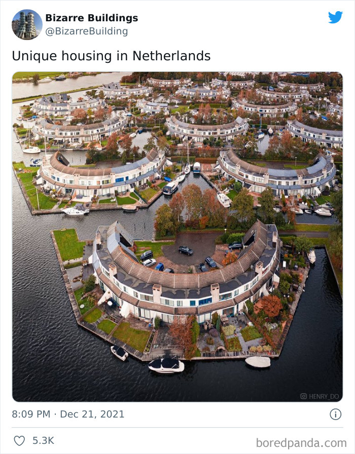 Aerial view of unique and cool architectural housing in the Netherlands with curved buildings along waterways.