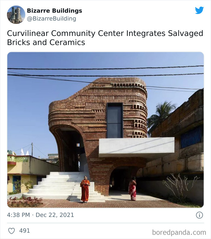 Curvilinear building with salvaged bricks and ceramics, showcasing unique architecture that may be uncomfortable to use.