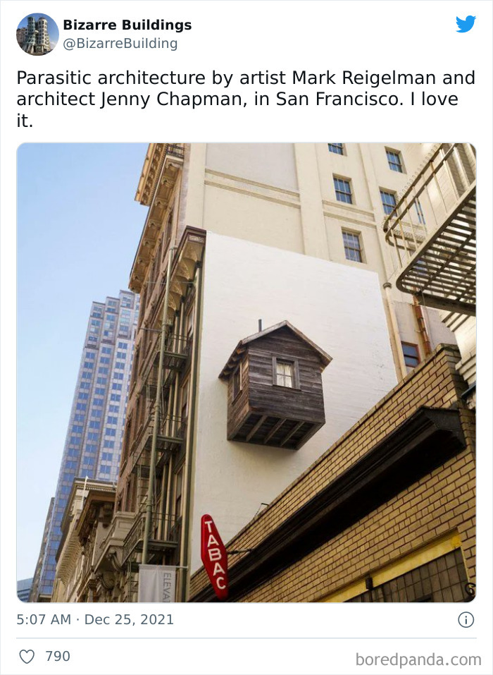 Small wooden house structure mounted awkwardly on the side of a building, showcasing unique and cool architecture design.
