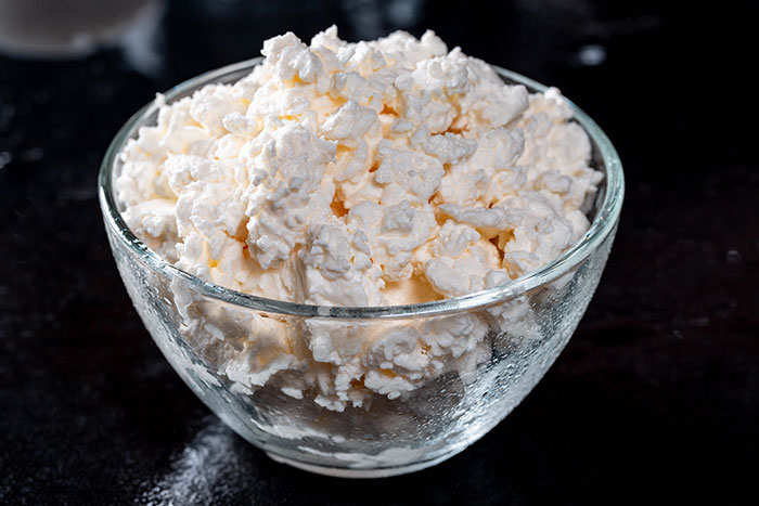 Bowl of cottage cheese viewed close-up, representing one of the inedible foods discussed by adventurous eaters.