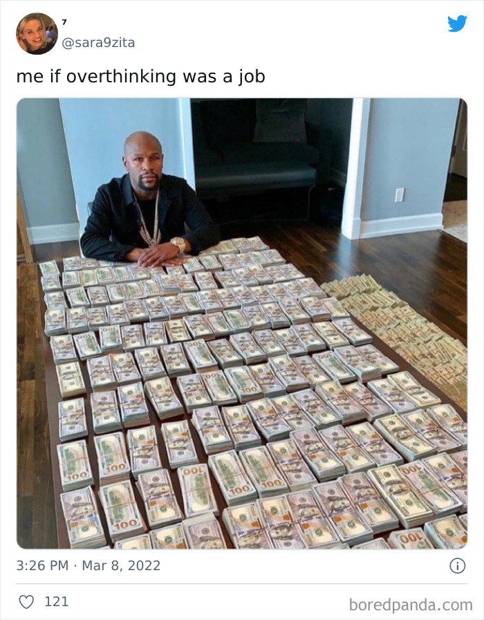 Person sitting at a table covered with stacks of money, captioned "me if overthinking was a job."