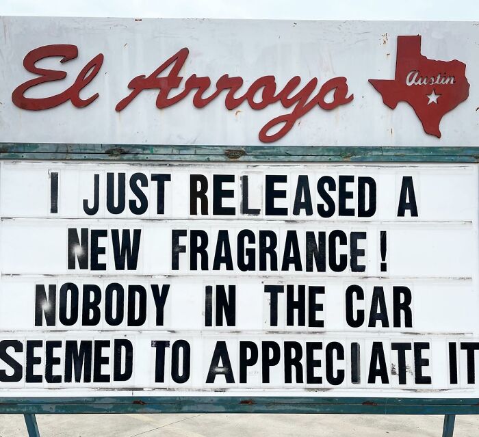 A humorous restaurant sign reads: "I just released a new fragrance! Nobody in the car seemed to appreciate it."