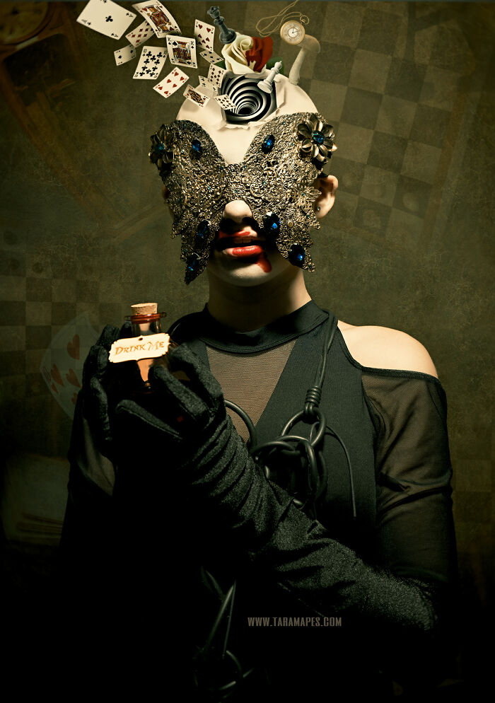 Dark Alice interpretation with ornate mask and "Drink Me" bottle, cards swirling above her head.