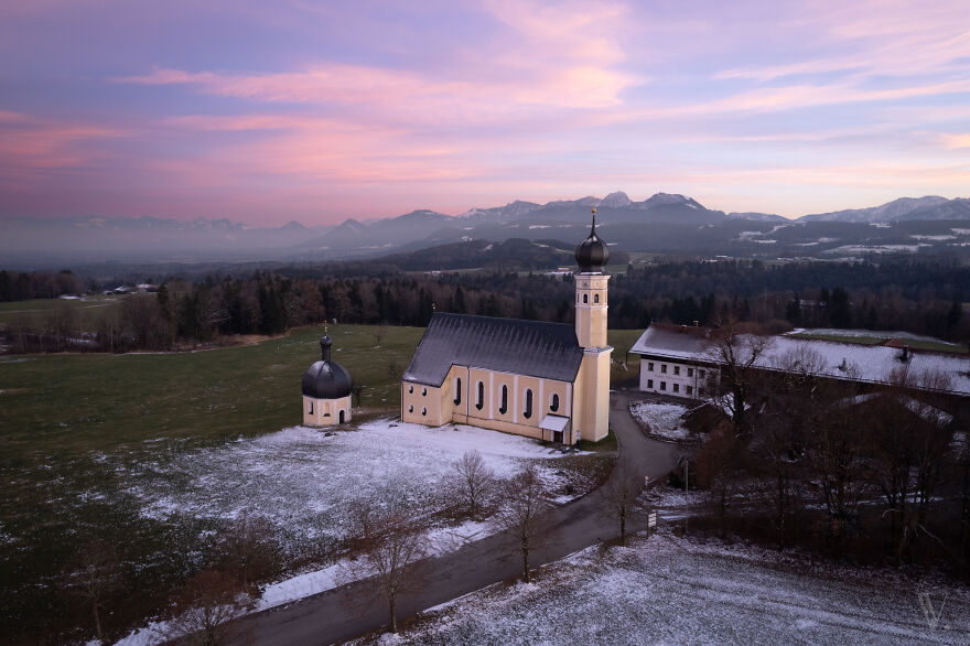 A Typical Bavarian Church (Germany). The Mountains In The Background Are In Austria