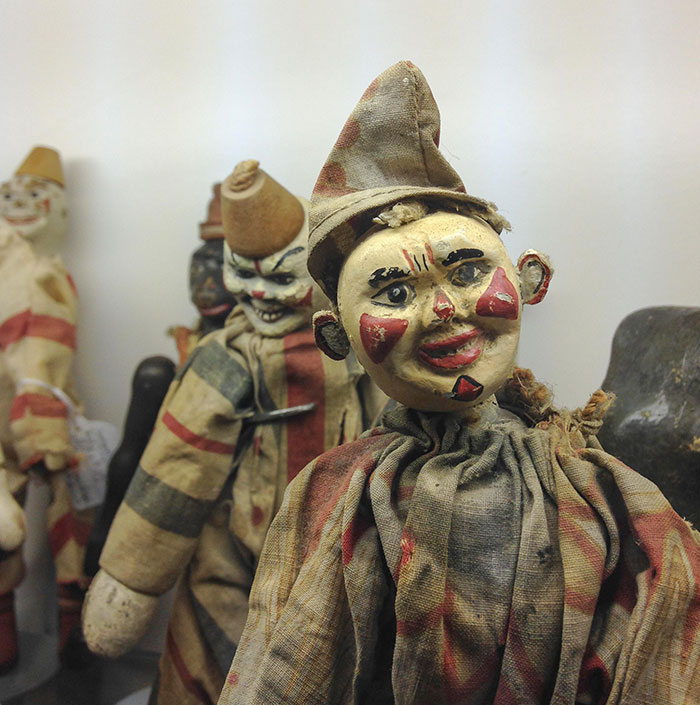 Vintage creepy clown toys with worn fabric and eerie painted faces, perfect examples of nightmare-inducing creepy toys.