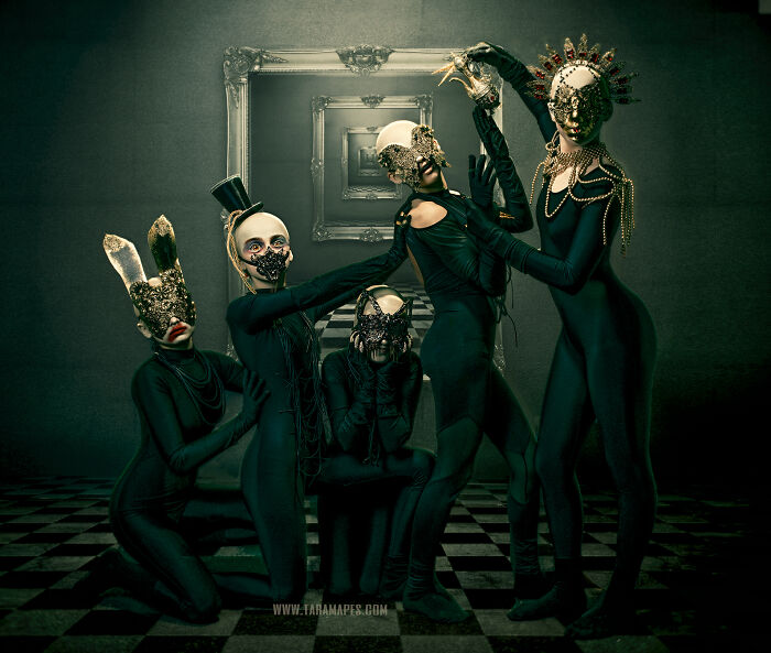Dark Alice interpretation with five masked figures in elaborate costumes on a checkered floor.