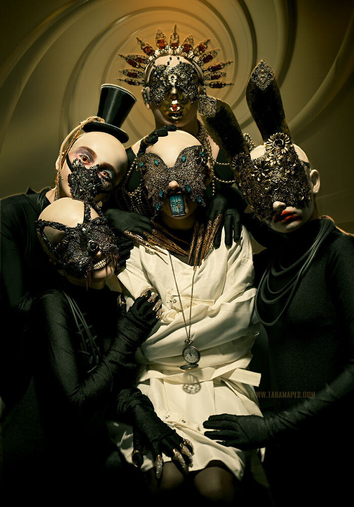 Dark Alice art scene with four masked figures in ornate costumes, featuring dark, surreal Alice in Wonderland elements.