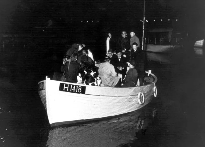 A group of people on a small boat at night, illustrating unexpected acts of kindness in history.
