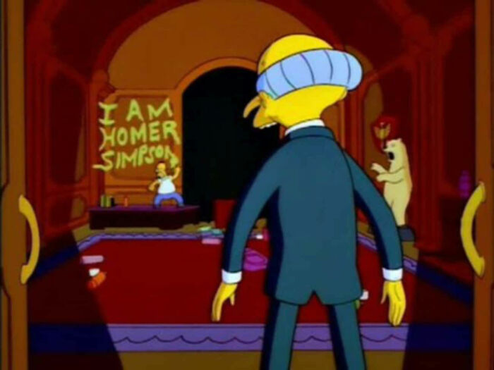 Scene from The Simpsons showing a secret message about Homer with Mr. Burns in a dark room.
