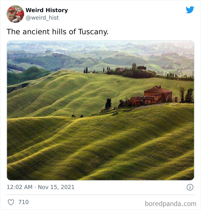 View of ancient green rolling hills in Tuscany with a rustic farmhouse illustrating weird history landscapes.