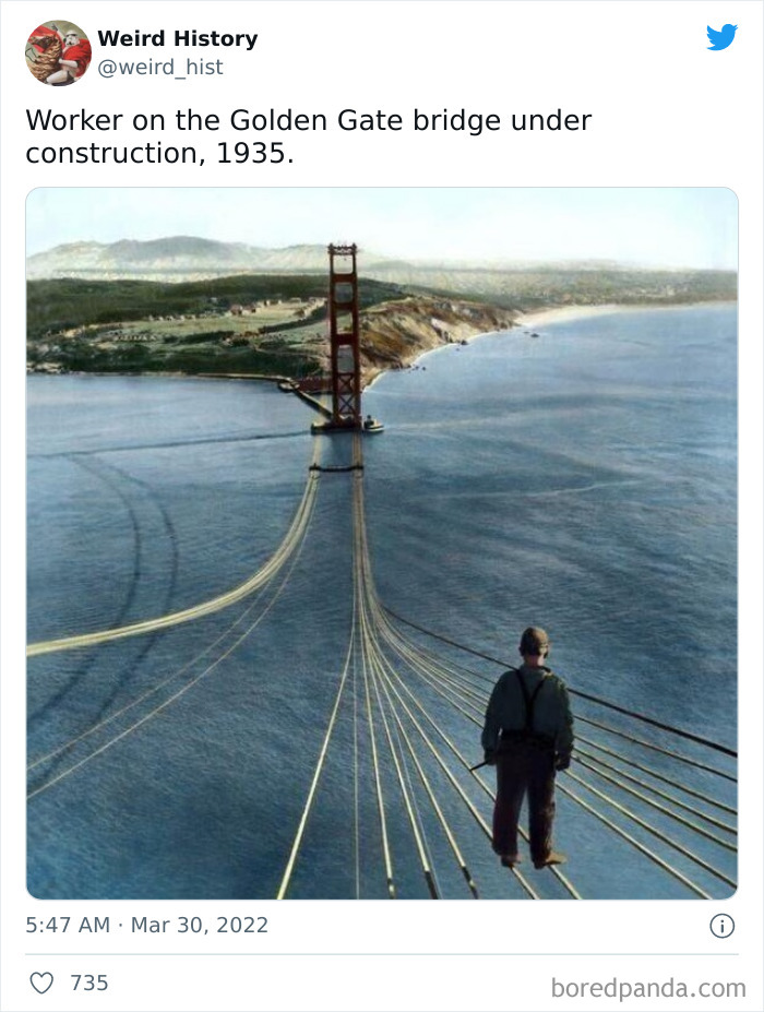 Worker standing on cables of Golden Gate Bridge during construction in 1935, illustrating weird history and odd historical moments.