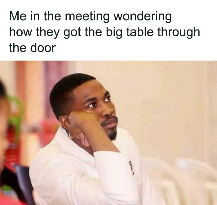 Person in a meeting looking bored, captioned with humorous office life thoughts about a big table.
