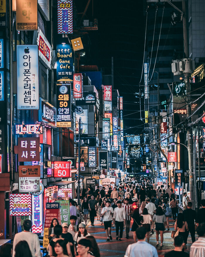 Night street scene in Seoul crowded with people and illuminated signs, showcasing the vibrant beauty of the city nightlife.