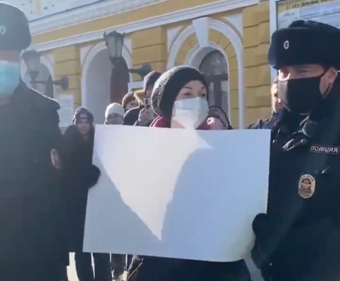 Arrested For Holding Up A Blank Sign