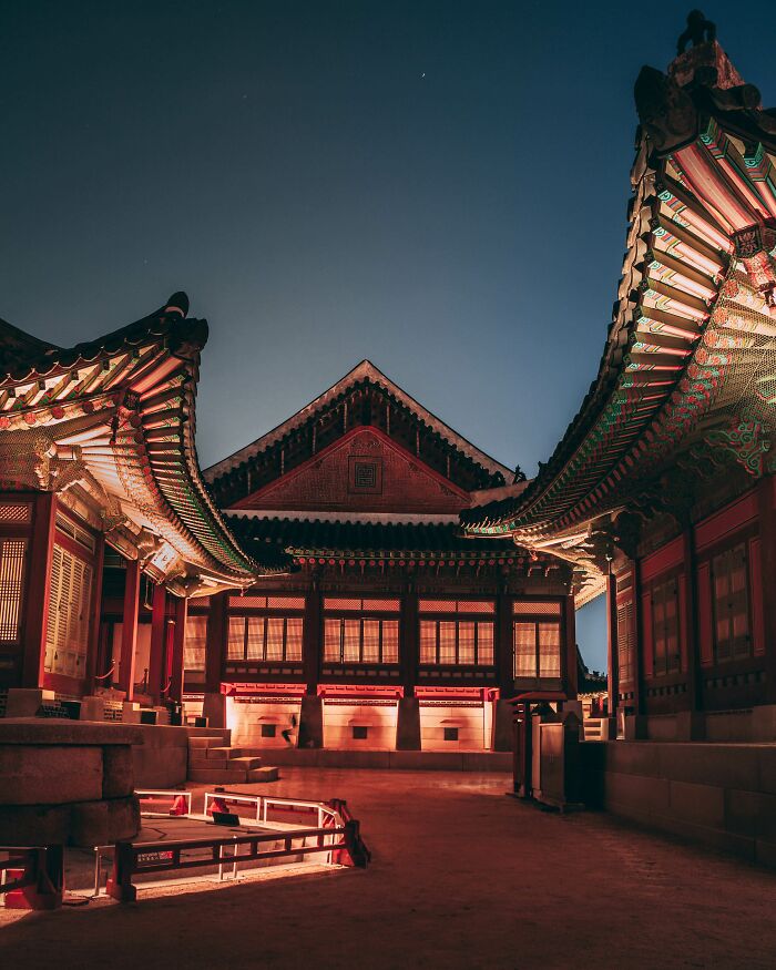 Traditional Korean palace architecture in Seoul illuminated at night showcasing the beauty of the cityscape.