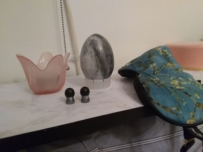 A Mini Light, A Marble Oval Ball On A Spice Lid, A Mask And My Earplugs And My Powder Container