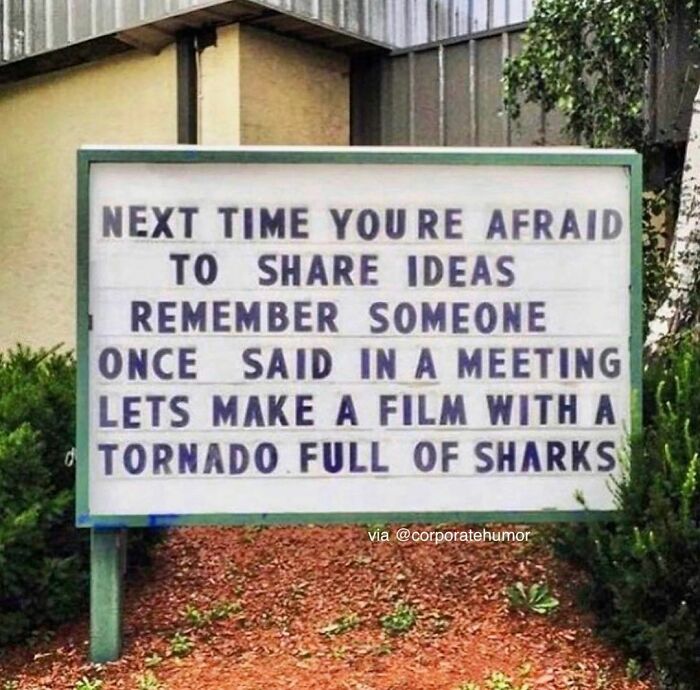 Corporate humor sign about sharing wild ideas in meetings.