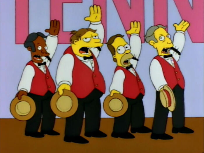 Characters from The Simpsons dressed in red vests and hats performing in a musical scene, highlighting fan theories about Homer.