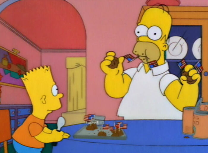 Homer and Bart Simpson in kitchen with mini American flag decorations on plates, showcasing Simpsons fan theories and details.