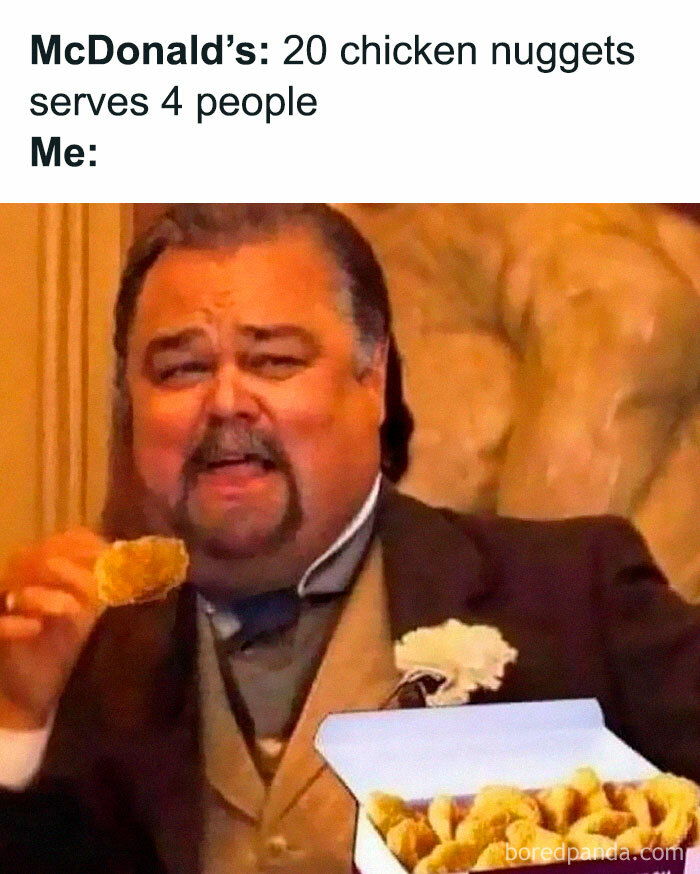 Man humorously eating box of chicken nuggets, illustrating a millennial meme.