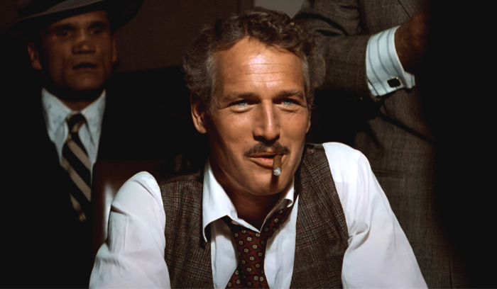 Paul Newman in a costume smoking