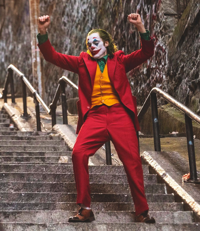 Joaquin Phoenix as a clown dancing on the stair