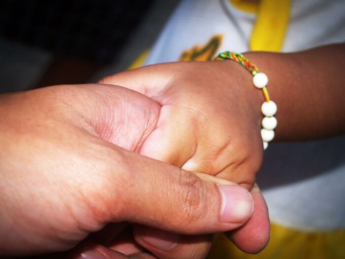 Close-up of two hands holding, symbolizing connection and hope in stories from people who came back to life.