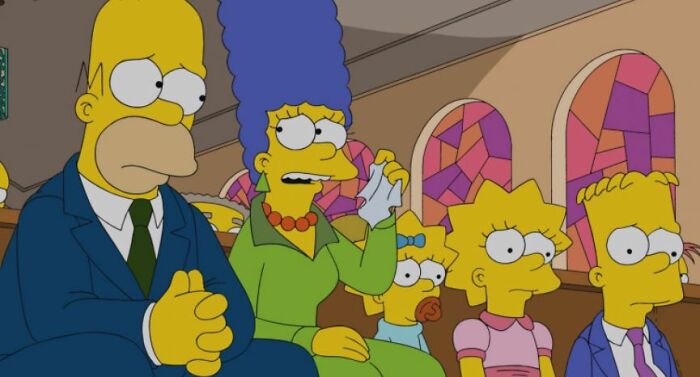 The Simpsons family attending a serious event, highlighting fan theories about small show details and Homer.