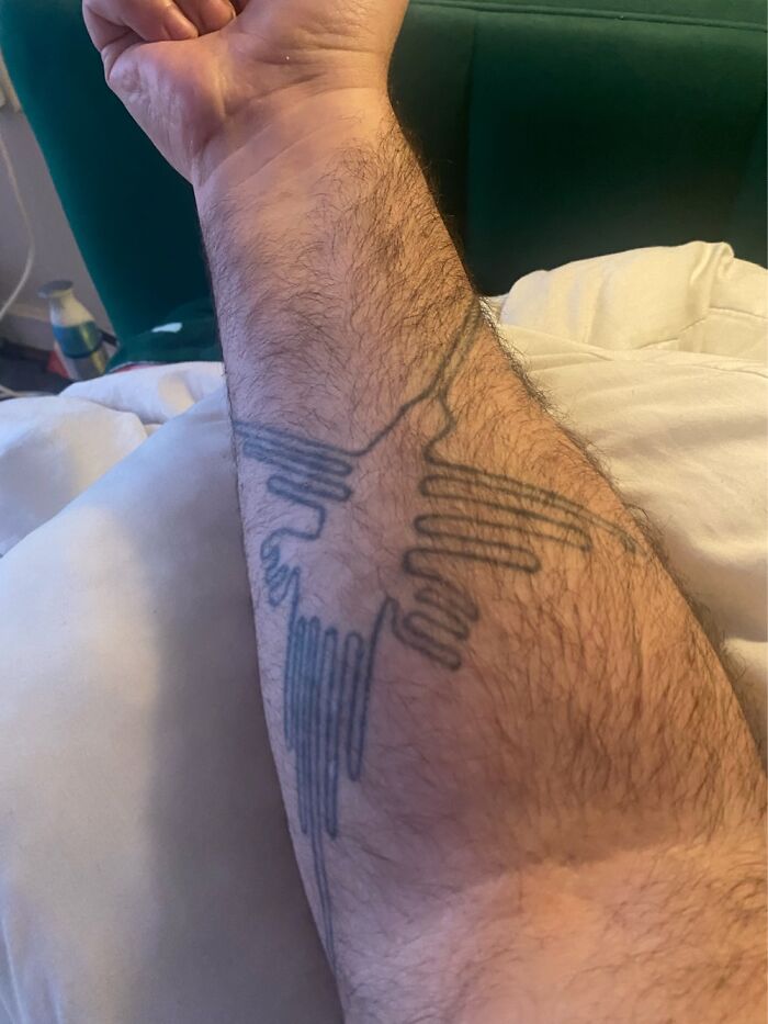 Forearm tattoo of stylized bird design, showcasing personal tattoos.