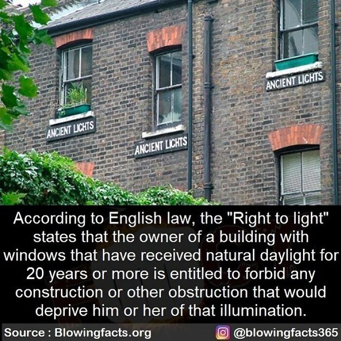 Old brick building with signs reading ancient lights and text about English law on right to light protections.