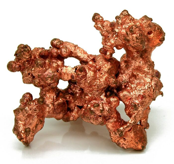 Close-up of a rough, irregular copper nugget resembling disturbing features found in human bodies and anatomy.