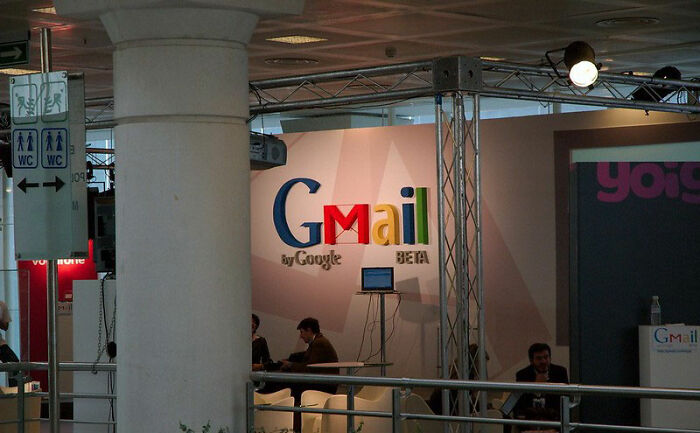 Gmail booth at an event, showcasing Google’s email service during its beta phase with visitors seated nearby.