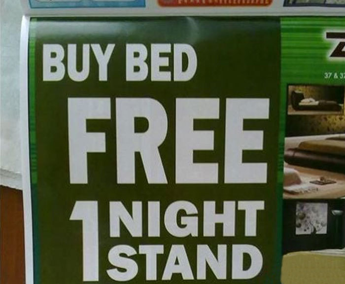 Sign with humorous wording offering free 1 night stand when buying a bed, showcasing hilarious and absurd signs.