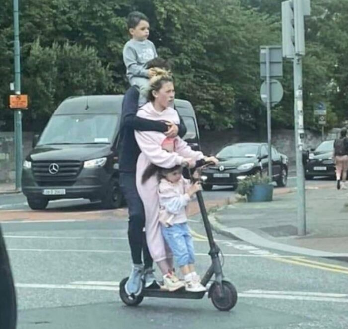 Family of four riding together on an electric scooter in Ireland, capturing the Irish sense of humor and everyday life.