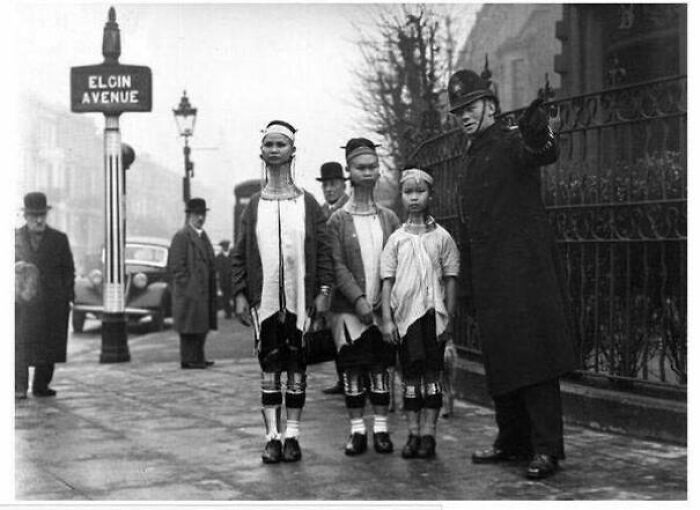 A Policeman In London Directing Three Giraffe-Necked Women From Burma, 1935