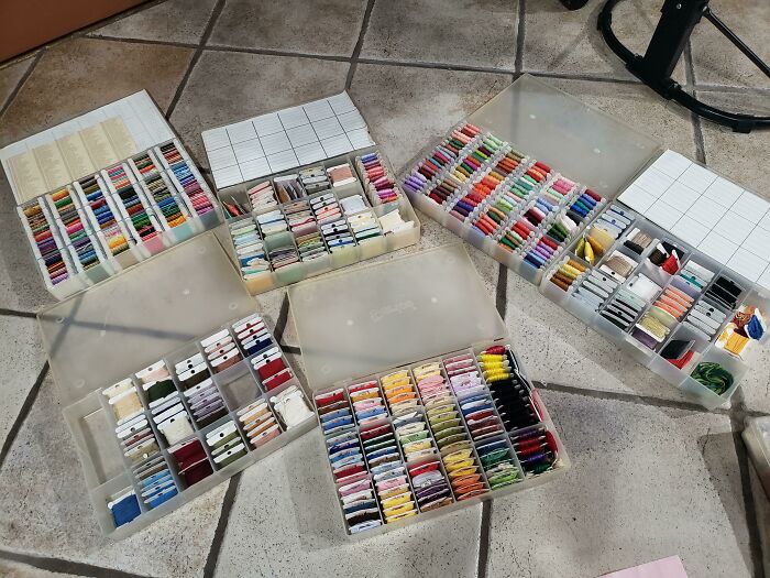 Organized colorful threads in plastic boxes, showcasing creativity and care often seen in the best mothers-in-law collections.