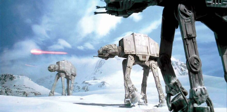 Battle of Hoth scene with snow-covered mountains, and three AT-AT Walkers (All Terrain Armored Transport) are shooting