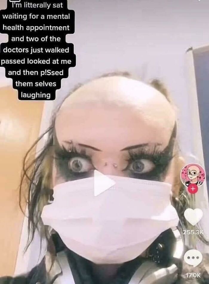 Close-up of a person with a unique hairstyle, wearing dramatic makeup and a mask, showcasing one of the worst hairstyles.