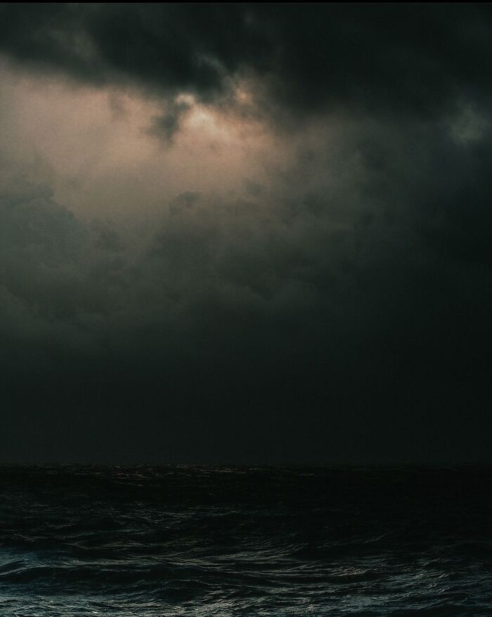 Dark turbulent ocean under a stormy sky evoking deep fear and anxiety related to thalassophobia and deep waters.