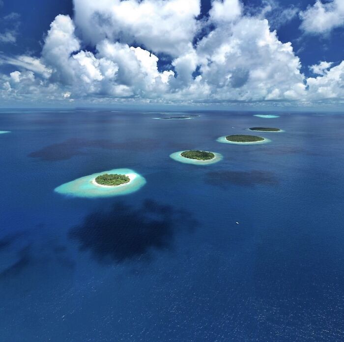 Aerial view of small islands surrounded by deep blue ocean waters, illustrating thalassophobia fear of deep waters.