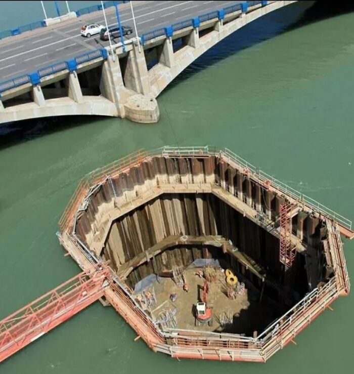 Construction site with deep waters around a large excavation pit, illustrating thalassophobia fear of deep waters.