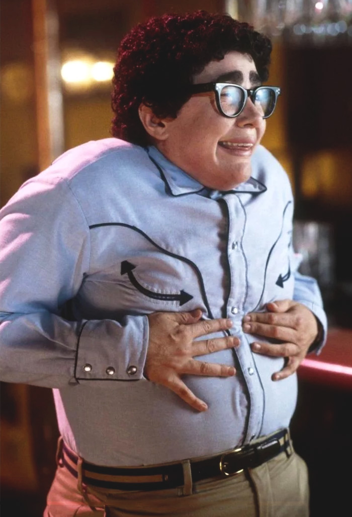 Pat touching his stomach and smiling