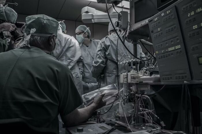 Surgical team performing operation in a hospital room with medical equipment, highlighting stories of waking up during surgery.